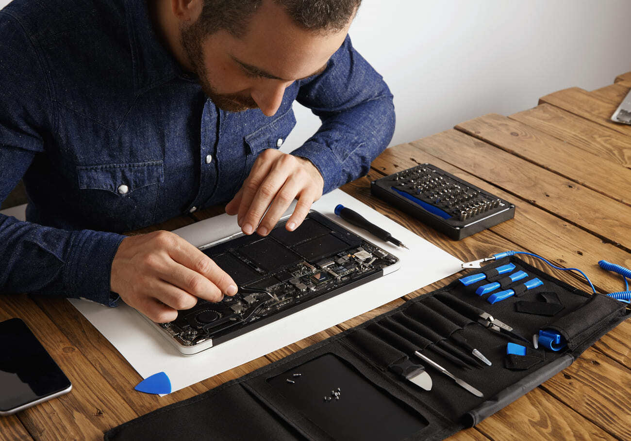 master-uses-angled-esd-tweezers-remove-dust-from-electronic-boards-broken-slim-computer-laptop-fix-it-make-work-again